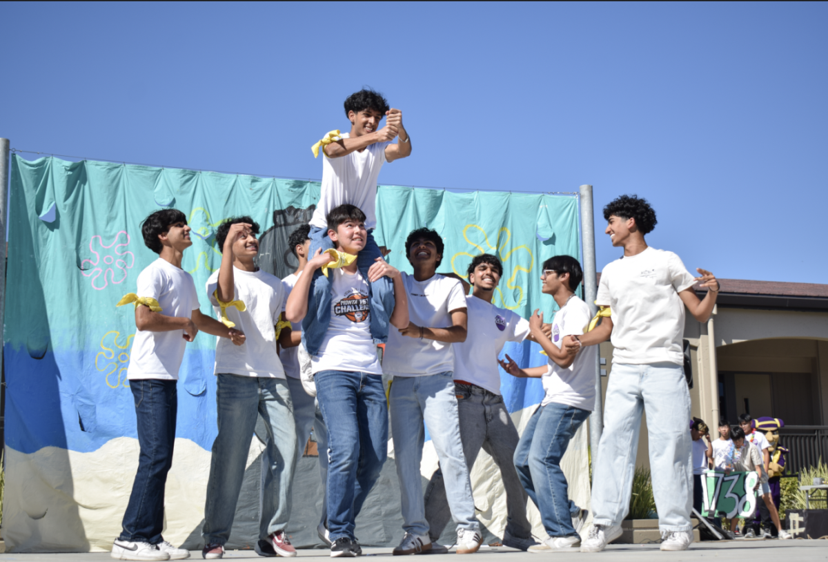 Junior Kavya Kumar sits on the shoulders of Junior Sean Foo while trying to use the confetti popper.



Photo by Arjun Dhruv
